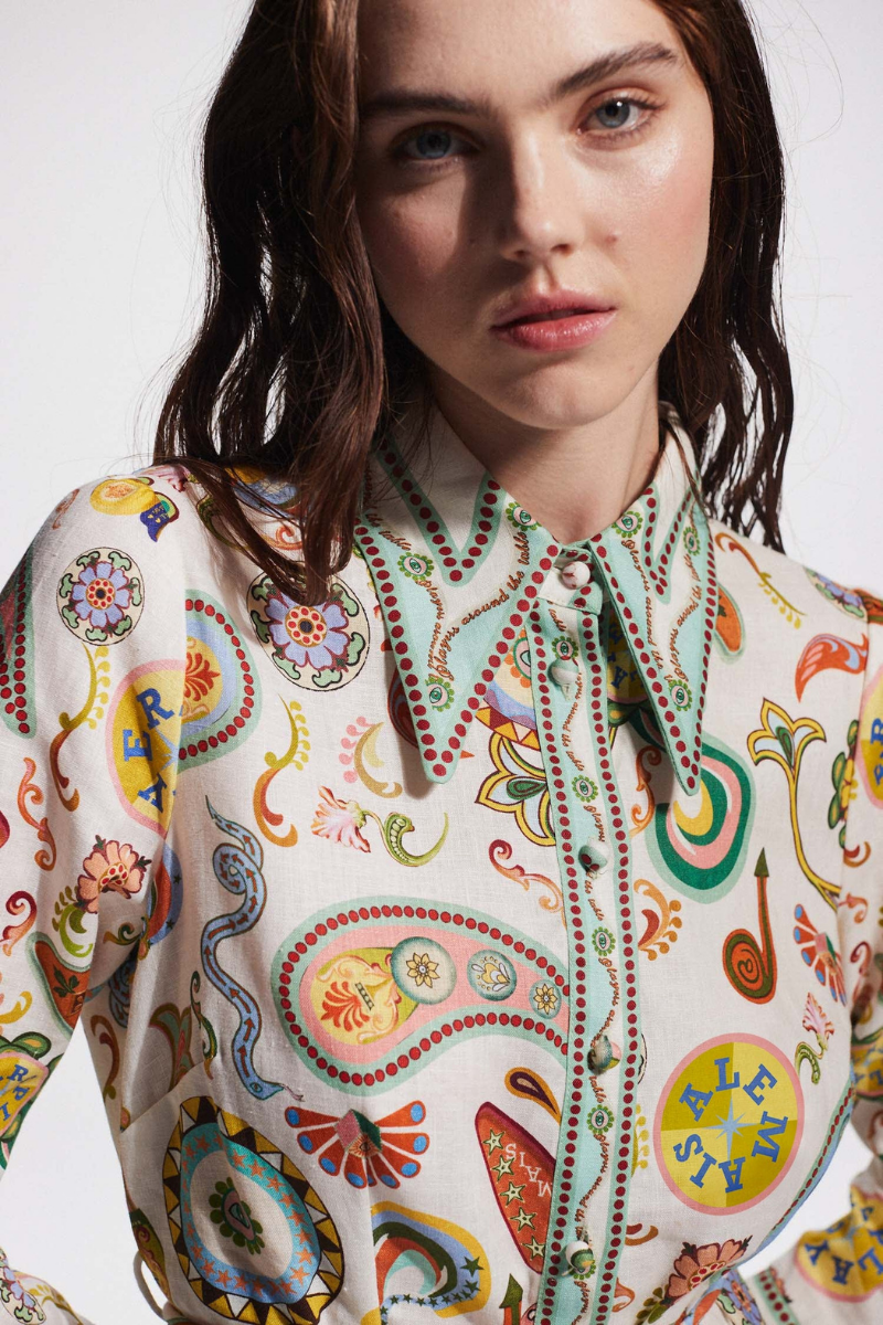 Multicolor - Full-length studio shot of a female model wearing a long-sleeved, collared mini shirt dress featuring a colourful paisley print, cinched at the waist with a tie-belt.