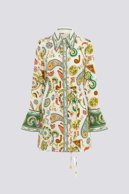 Multicolor - Full-length studio shot of a female model wearing a long-sleeved, collared mini shirt dress featuring a colourful paisley print, cinched at the waist with a tie-belt.