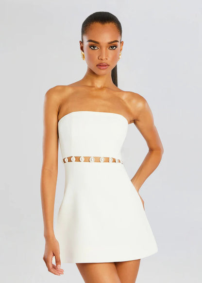 White - Women's elegant white strapless mini dress featuring a structured A-line silhouette and a distinctive waist cut-out adorned with large pearl embellishments.