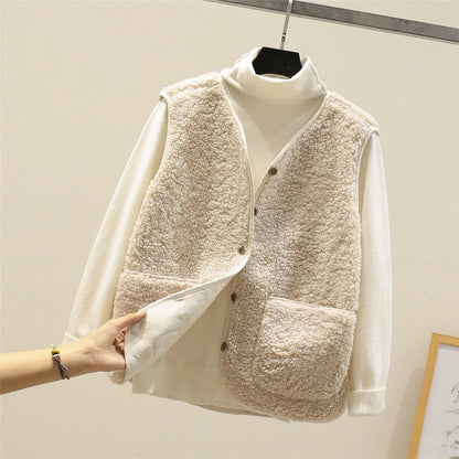 Khaki - Three women's faux shearling vests in cream, dark brown, and taupe hanging on wooden hangers, featuring a V-neck, button-front closure, and large patch pockets.
