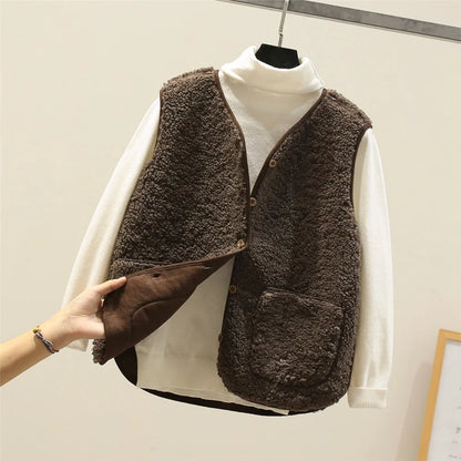 Khaki - Three women's faux shearling vests in cream, dark brown, and taupe hanging on wooden hangers, featuring a V-neck, button-front closure, and large patch pockets.