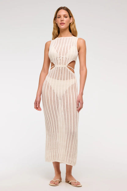 White - A woman models a sleeveless, cream-colored open-knit maxi dress with a high neckline and cutouts at the waist, shown against a plain white background.