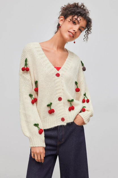 Apricot - Women's chunky knit V-neck cardigan featuring large front buttons and playful 3D crochet cherry appliqués scattered across a relaxed silhouette.