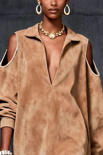 Khaki - A model wears a tan, long-sleeve, suede-finish mini tunic dress with a deep V-neck, a pointed collar, and cutouts at the shoulders. She is accessorized with gold jewelry and carries a brown handbag.