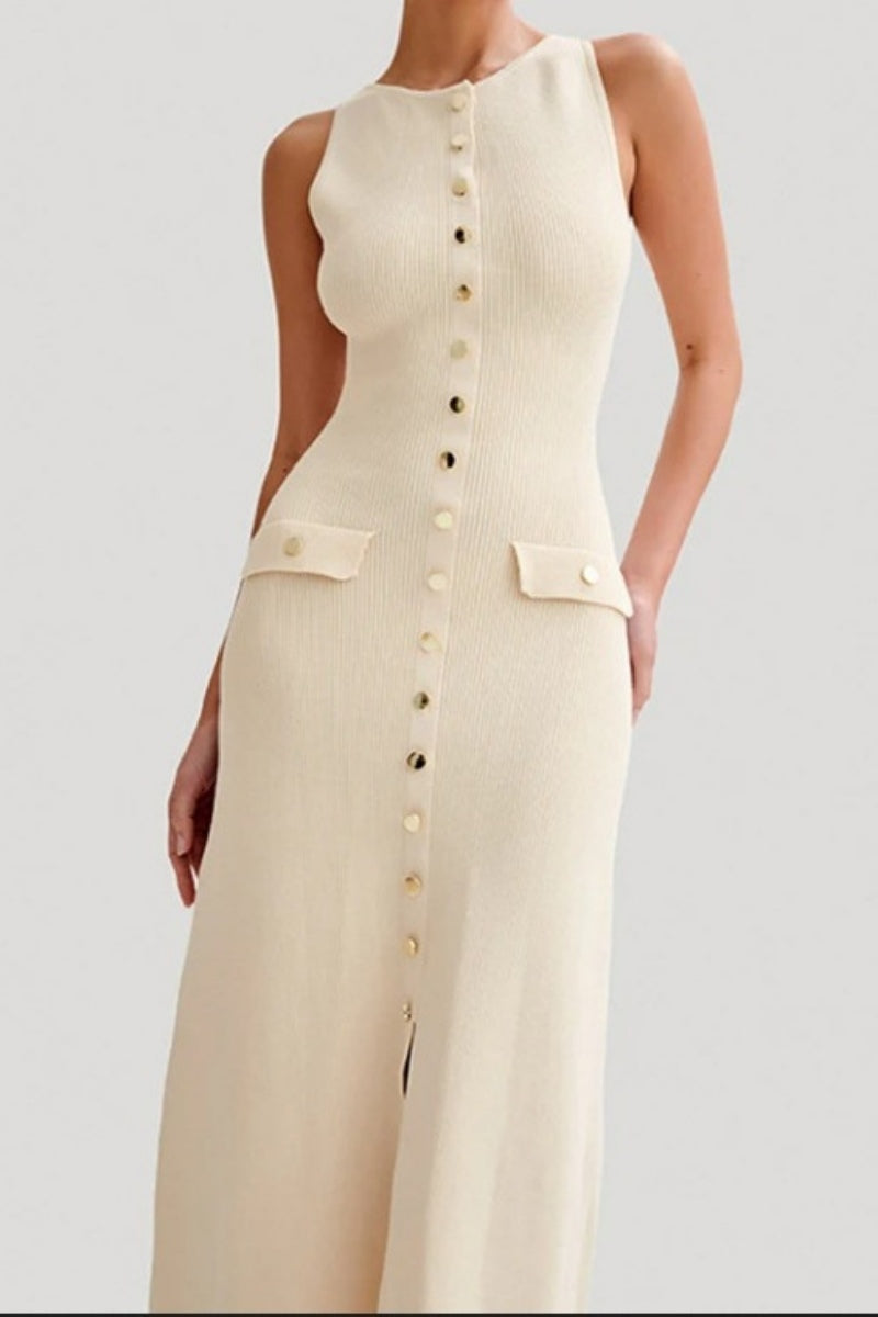 A woman wears a sleeveless, cream-colored ribbed knit midi dress featuring a high neckline, a full front placket of gold-tone buttons, and two small flap pockets at the hips.