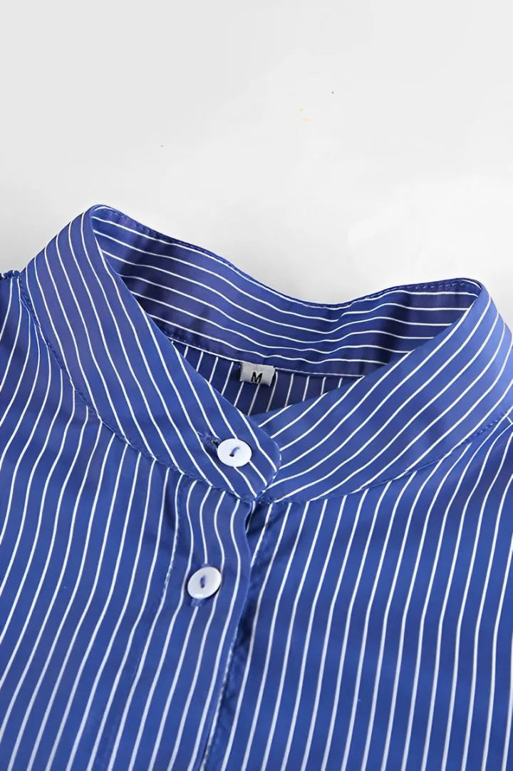 Woman in oversized blue and white striped shirt with black pants