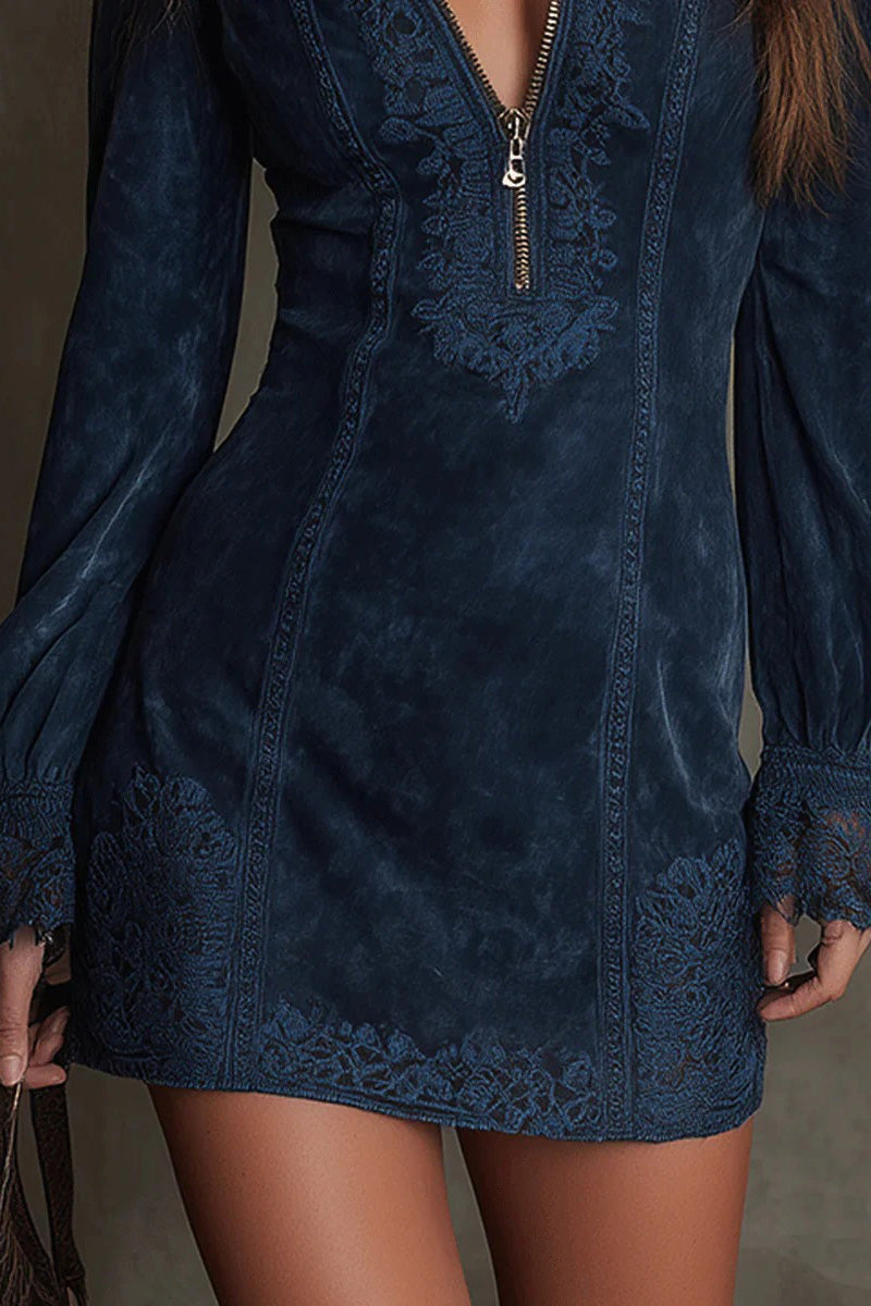 Green - Front view of a woman wearing a long-sleeved, fitted brown mini dress with a suede-like texture. The dress features a zip-front neckline, intricate floral embroidery on the bodice and seams, and wide lace trim on the cuffs and hem.