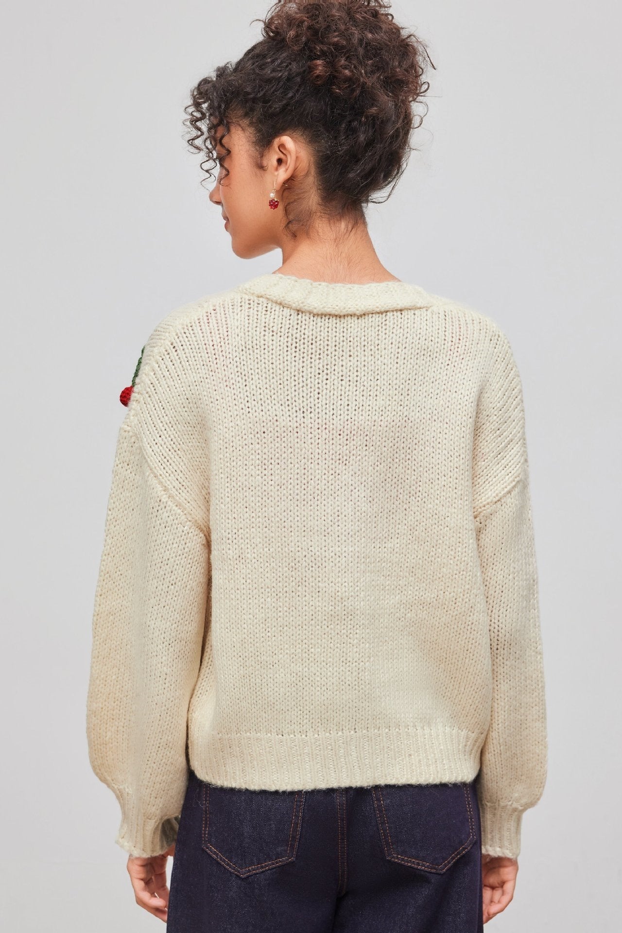 Apricot - Women's chunky knit V-neck cardigan featuring large front buttons and playful 3D crochet cherry appliqués scattered across a relaxed silhouette.