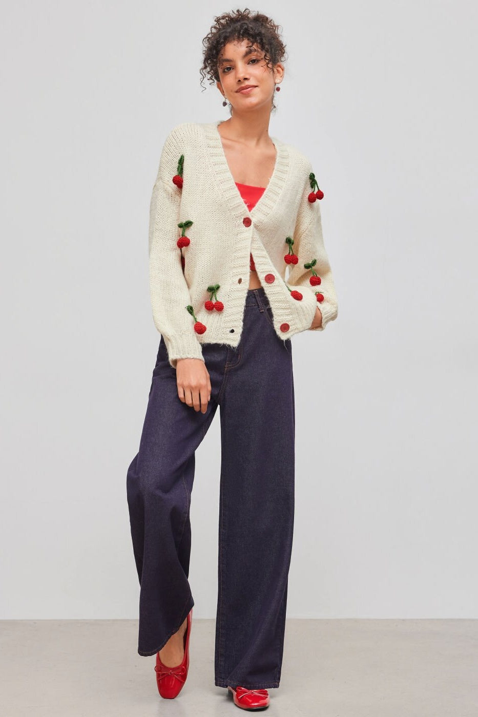 Apricot - Women's chunky knit V-neck cardigan featuring large front buttons and playful 3D crochet cherry appliqués scattered across a relaxed silhouette.