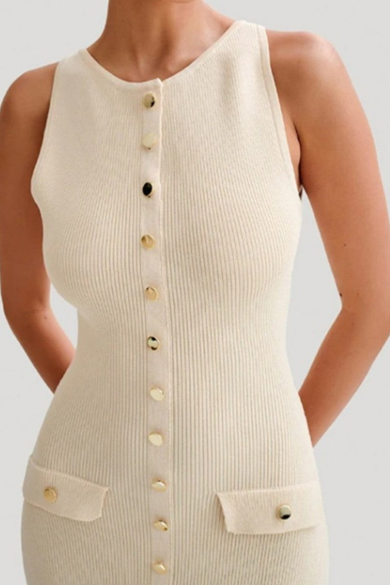 A woman wears a sleeveless, cream-colored ribbed knit midi dress featuring a high neckline, a full front placket of gold-tone buttons, and two small flap pockets at the hips.
