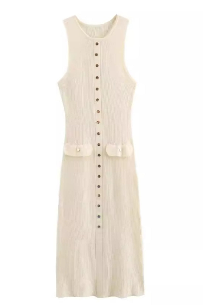 A woman wears a sleeveless, cream-colored ribbed knit midi dress featuring a high neckline, a full front placket of gold-tone buttons, and two small flap pockets at the hips.