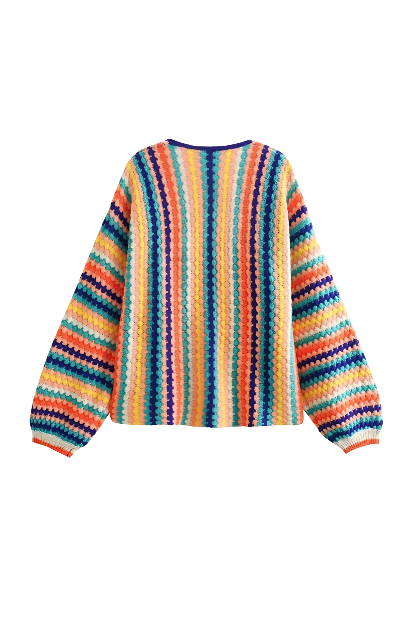 Rainbow - A woman wearing a vibrant, striped open-front crochet cardigan with ribbed cuffs, styled over a ribbed top and dark denim jeans on a city street.