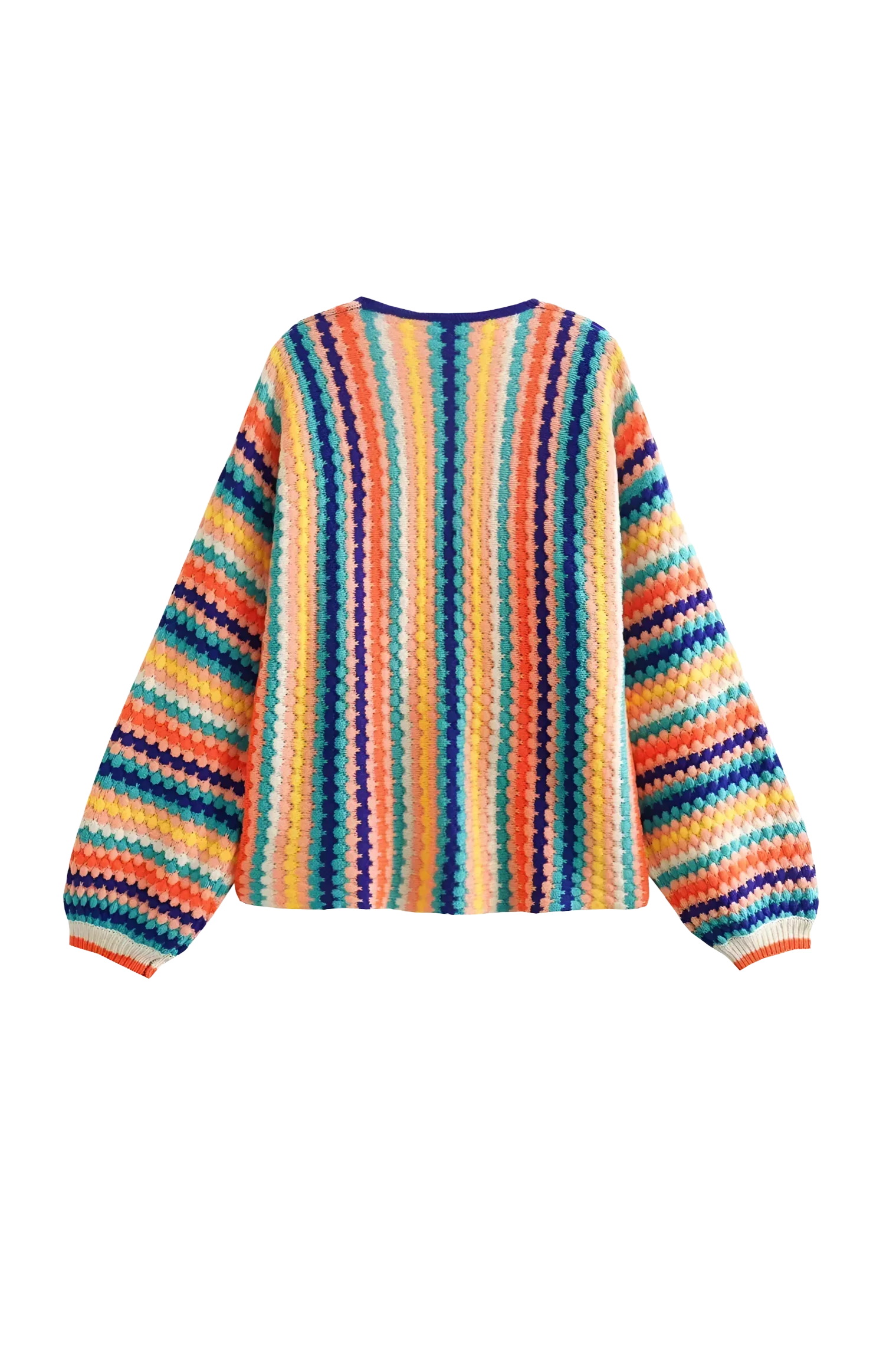 Rainbow - A woman wearing a vibrant, striped open-front crochet cardigan with ribbed cuffs, styled over a ribbed top and dark denim jeans on a city street.