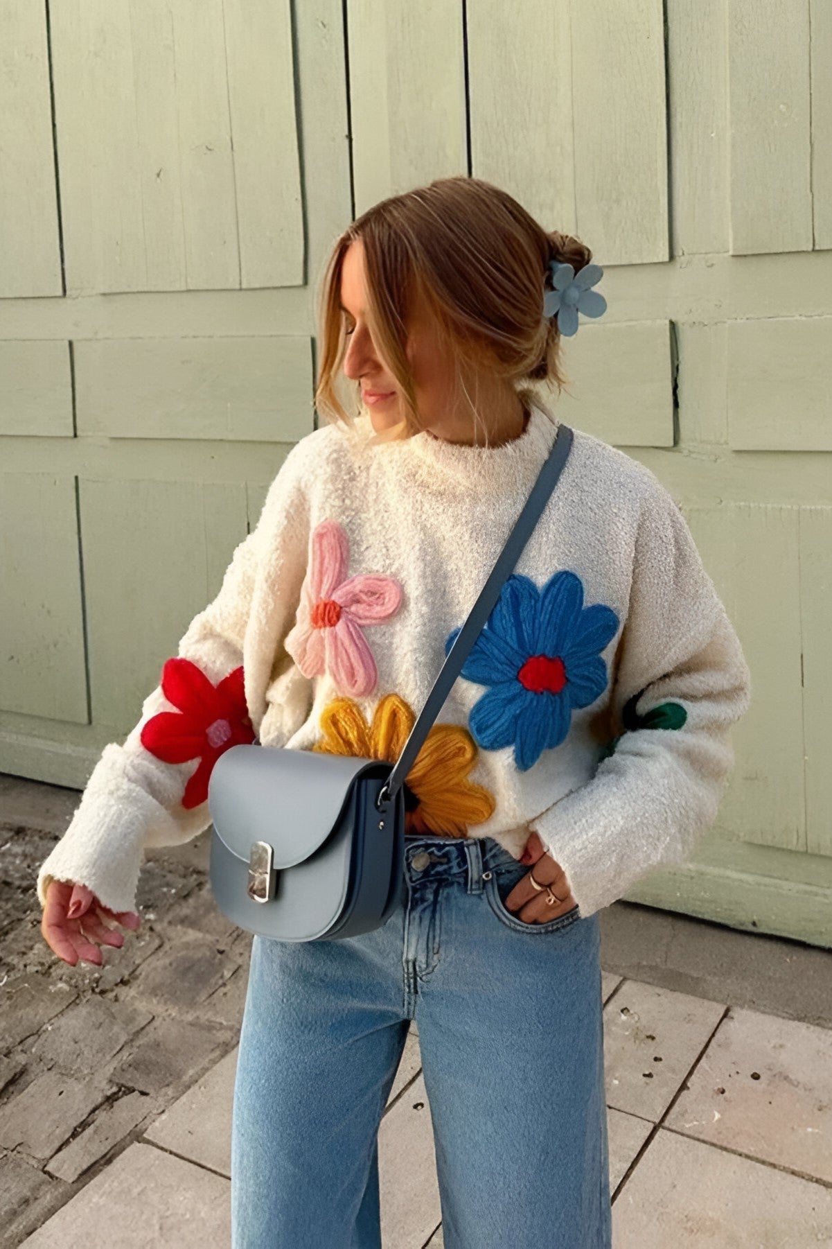 L - Women's fluffy cream mock neck jumper featuring oversized, colourful 3D yarn floral appliqués on the front and sleeves, styled with loose light-wash denim jeans.