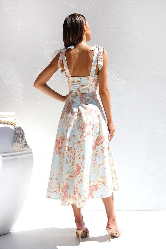 Woman in floral print sundress with tie straps