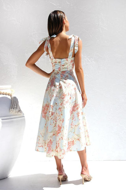 Woman in floral print sundress with tie straps
