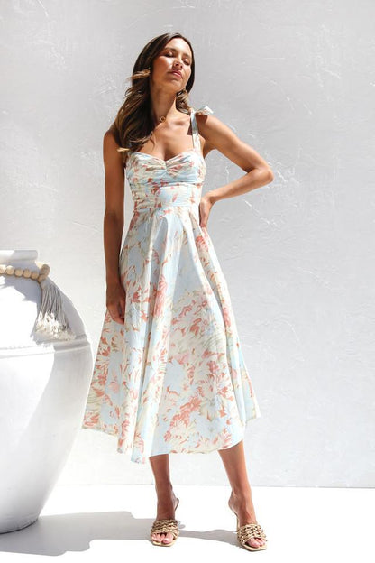 Woman in floral print sundress with tie straps