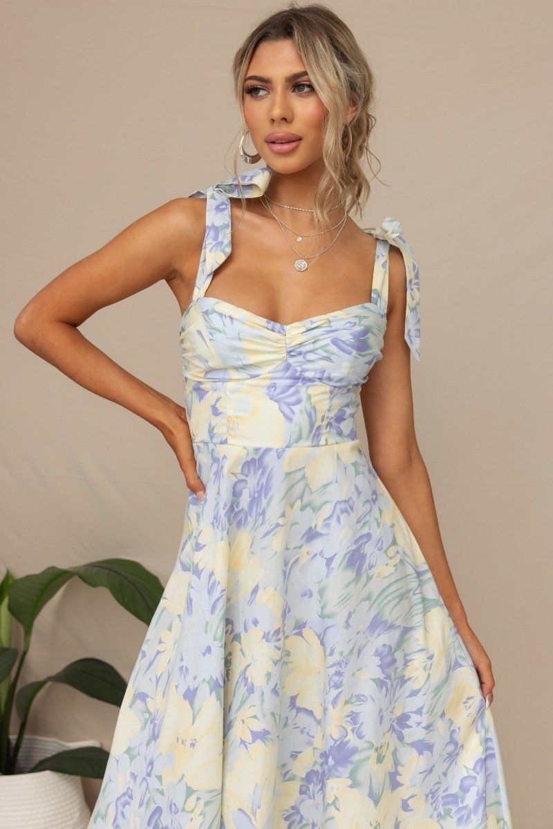 Woman in floral print sundress with tie straps