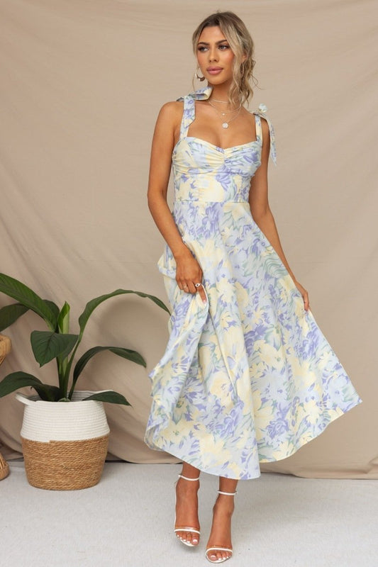Woman in floral print sundress with tie straps
