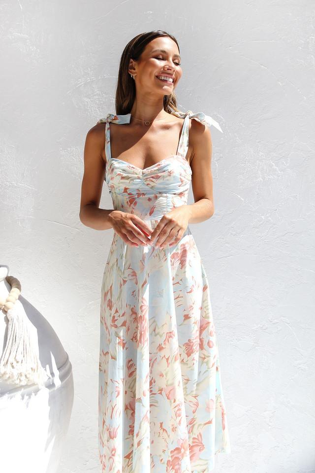 Woman in floral print sundress with tie straps