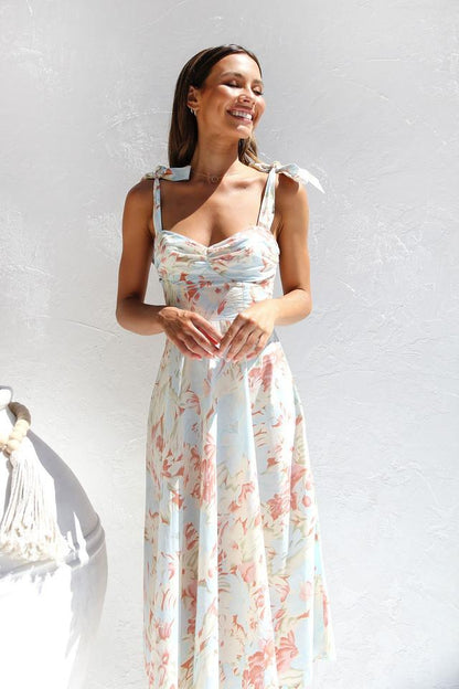 Woman in floral print sundress with tie straps