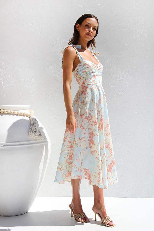 Woman in floral print sundress with tie straps