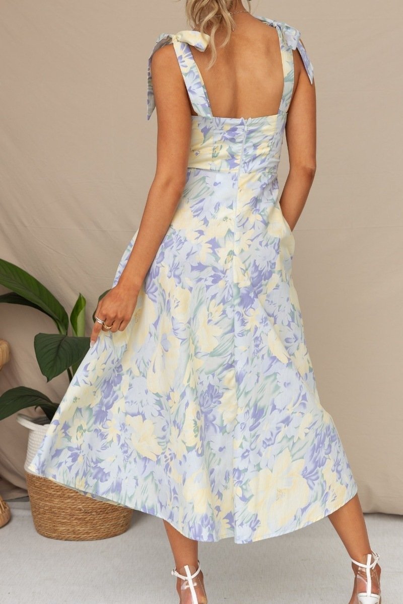 Woman in floral print sundress with tie straps