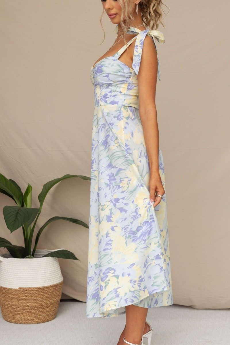 Woman in floral print sundress with tie straps