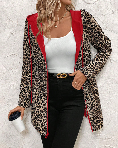 Black Polka - Women's mid-length red zip-up anorak jacket worn open to reveal a bold leopard print interior lining, featuring front pockets and an internal drawstring waist.