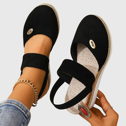 Black - Women's canvas platform sandals featuring an elastic slingback strap, braided jute trim, and a metallic logo accent on a thick cushioned sole.