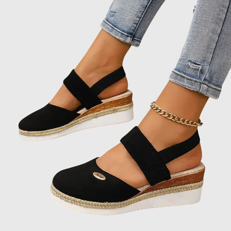 Gray - Women's canvas platform sandals featuring an elastic slingback strap, braided jute trim, and a metallic logo accent on a thick cushioned sole.