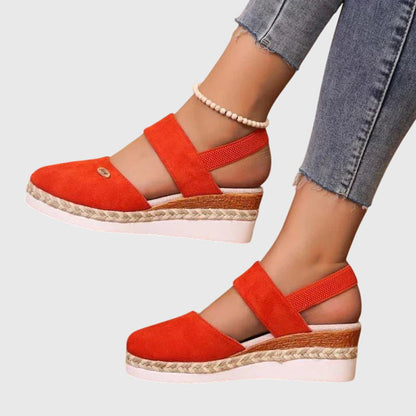 Orange - Women's canvas platform sandals featuring an elastic slingback strap, braided jute trim, and a metallic logo accent on a thick cushioned sole.