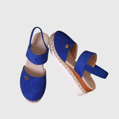 Blue - Women's canvas platform sandals featuring an elastic slingback strap, braided jute trim, and a metallic logo accent on a thick cushioned sole.