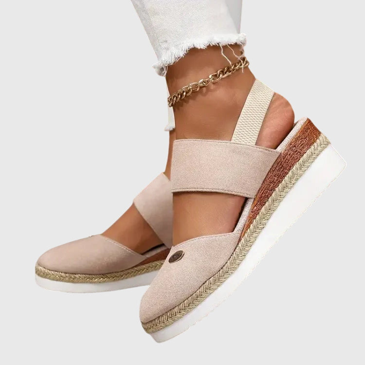 Blue - Women's canvas platform sandals featuring an elastic slingback strap, braided jute trim, and a metallic logo accent on a thick cushioned sole.