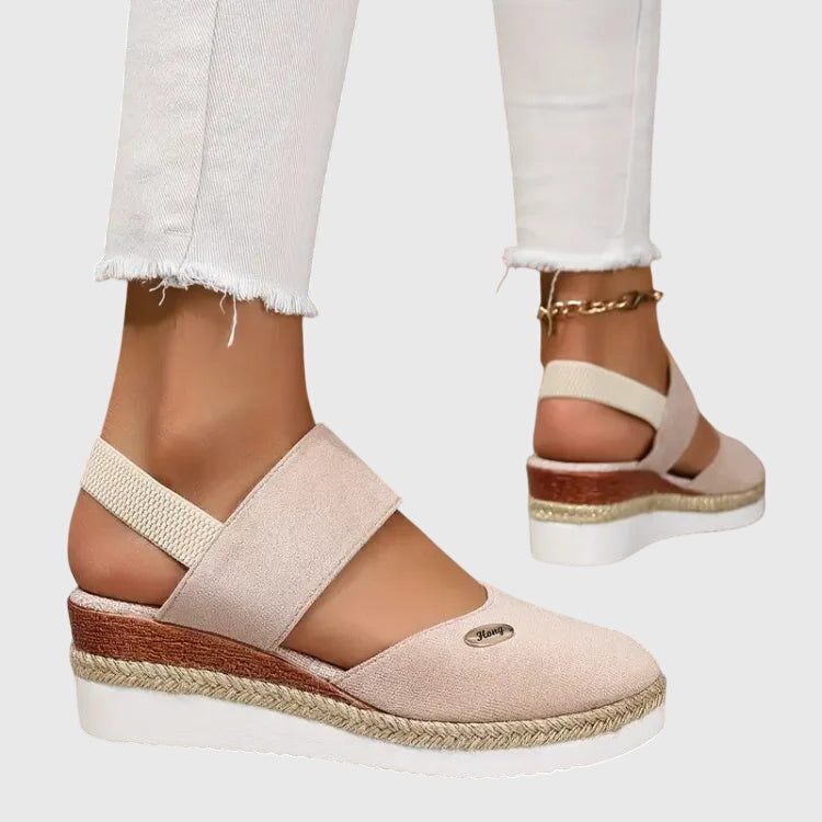 Blue - Women's canvas platform sandals featuring an elastic slingback strap, braided jute trim, and a metallic logo accent on a thick cushioned sole.