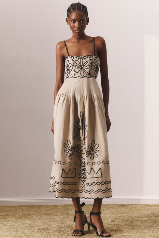 Woman in beige linen midi dress with black embroidery