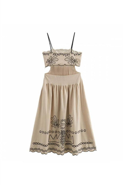 Woman in beige linen midi dress with black embroidery