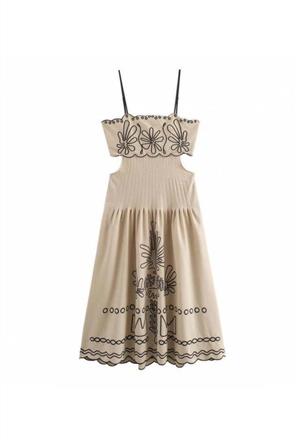 Woman in beige linen midi dress with black embroidery