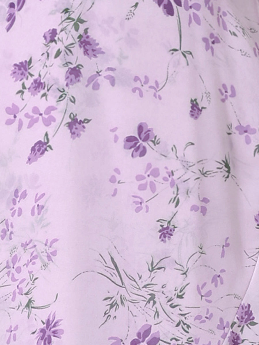 Purple - Woman walking outdoors wearing a sleeveless floral chiffon midi sundress with an asymmetrical high-low ruffle hem.
