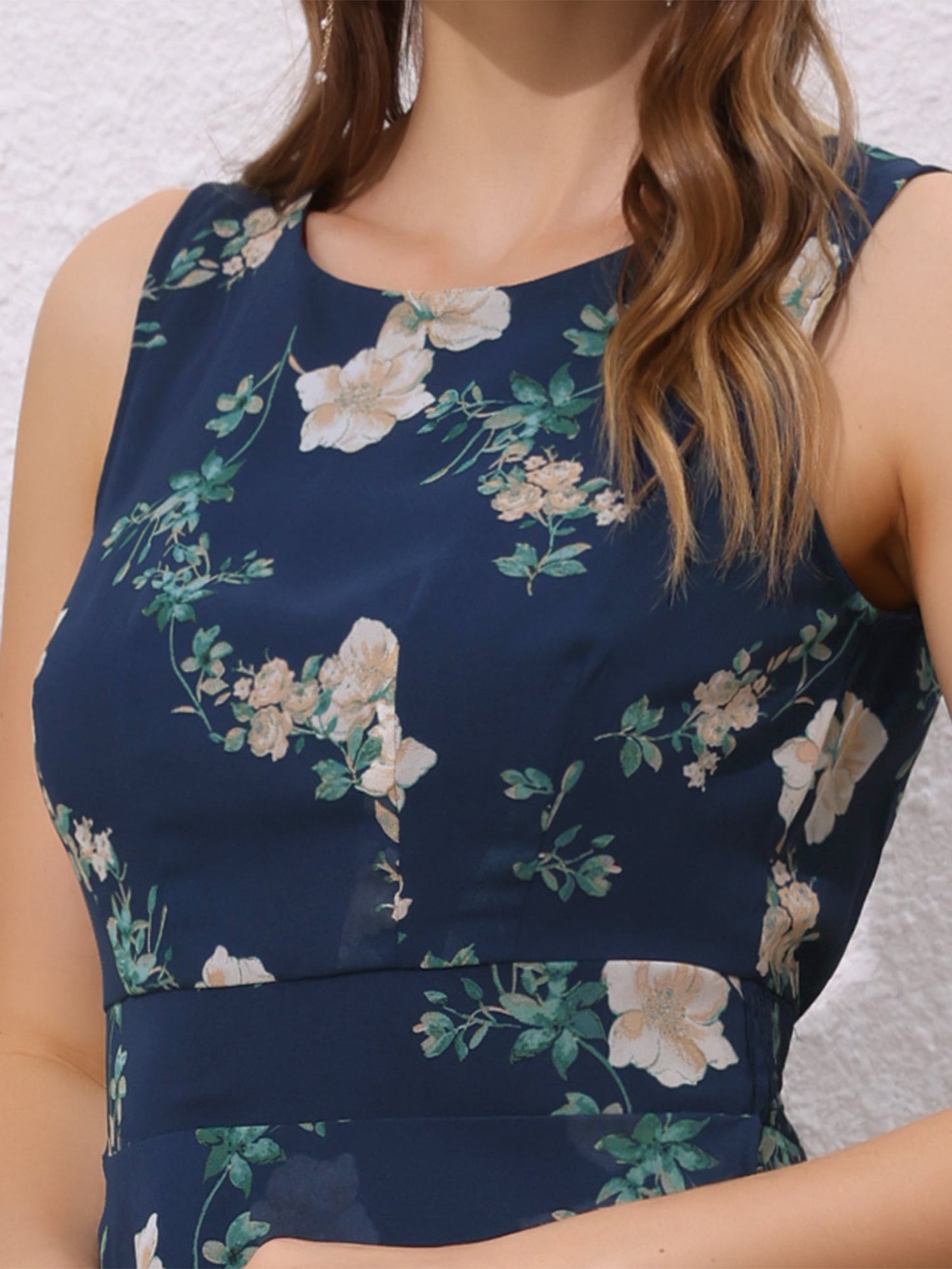 Dark Blue - Woman walking outdoors wearing a sleeveless floral chiffon midi sundress with an asymmetrical high-low ruffle hem.
