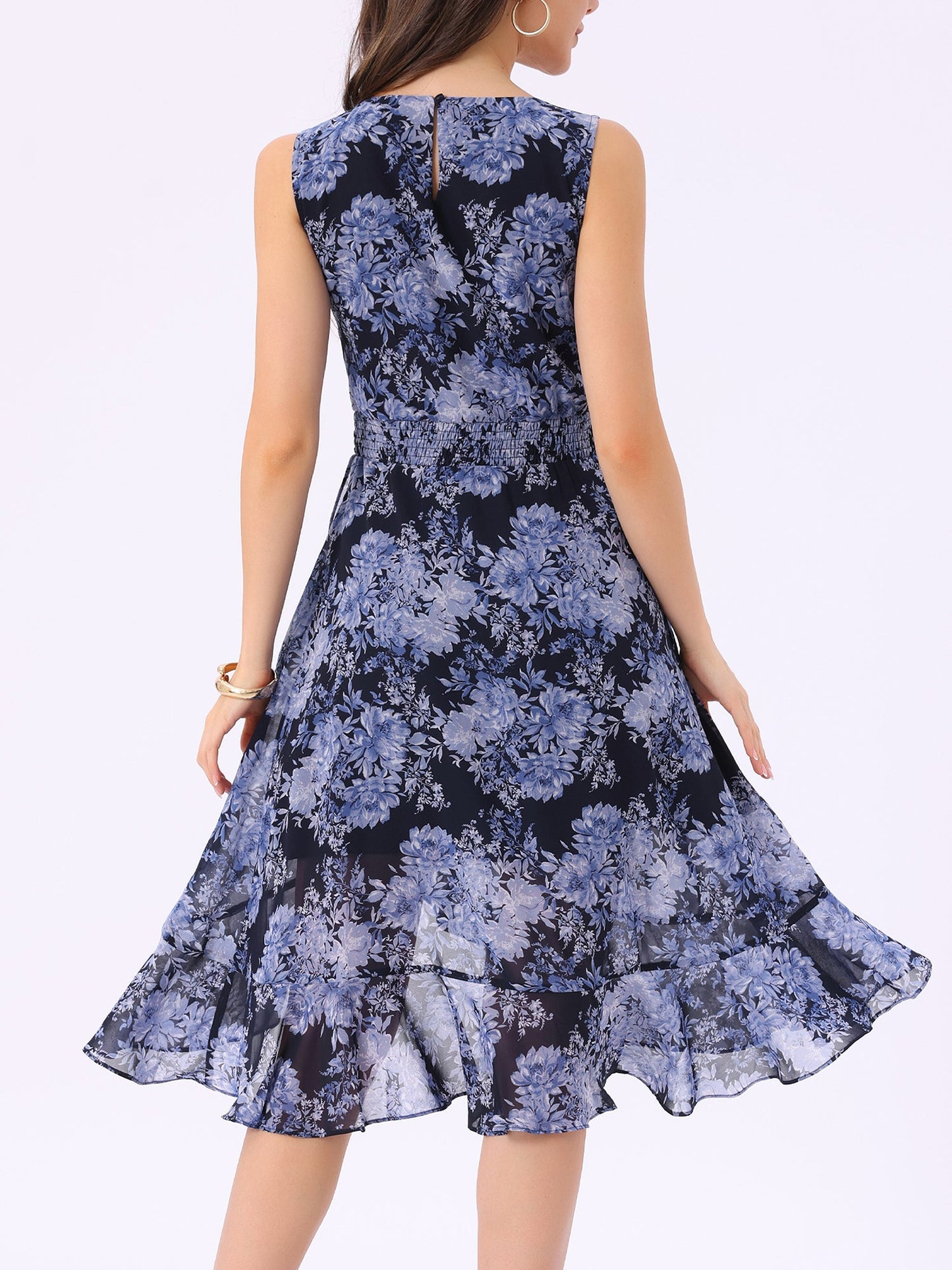 Navy Blue - Woman walking outdoors wearing a sleeveless floral chiffon midi sundress with an asymmetrical high-low ruffle hem.
