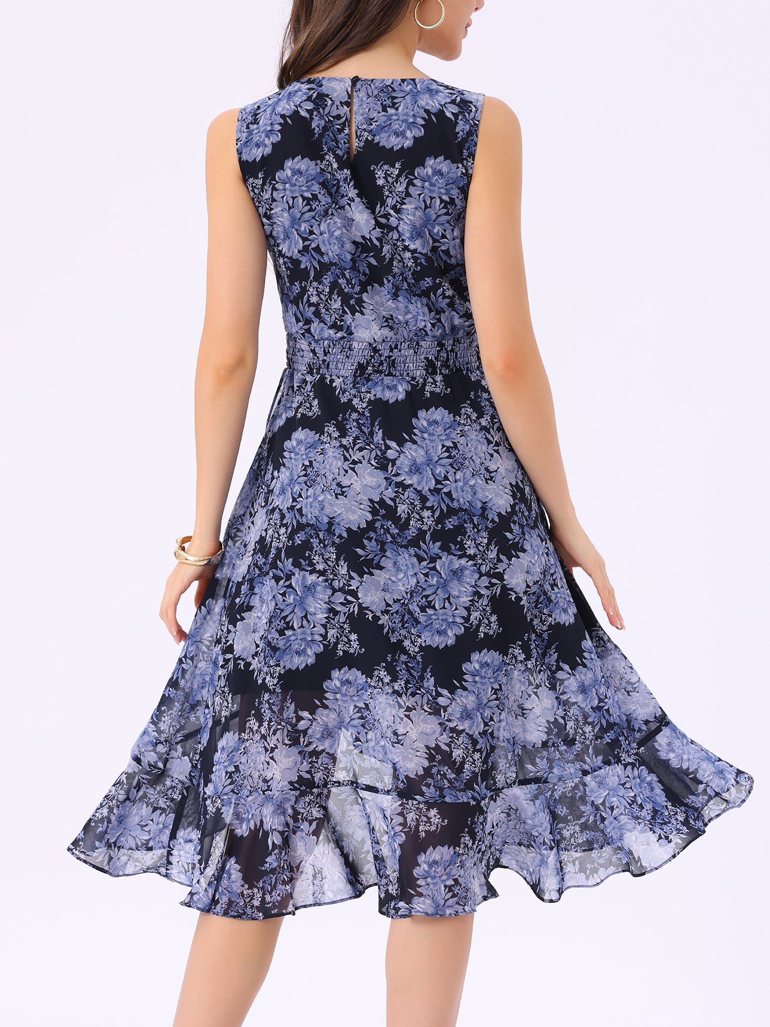 Navy Blue - Woman walking outdoors wearing a sleeveless floral chiffon midi sundress with an asymmetrical high-low ruffle hem.