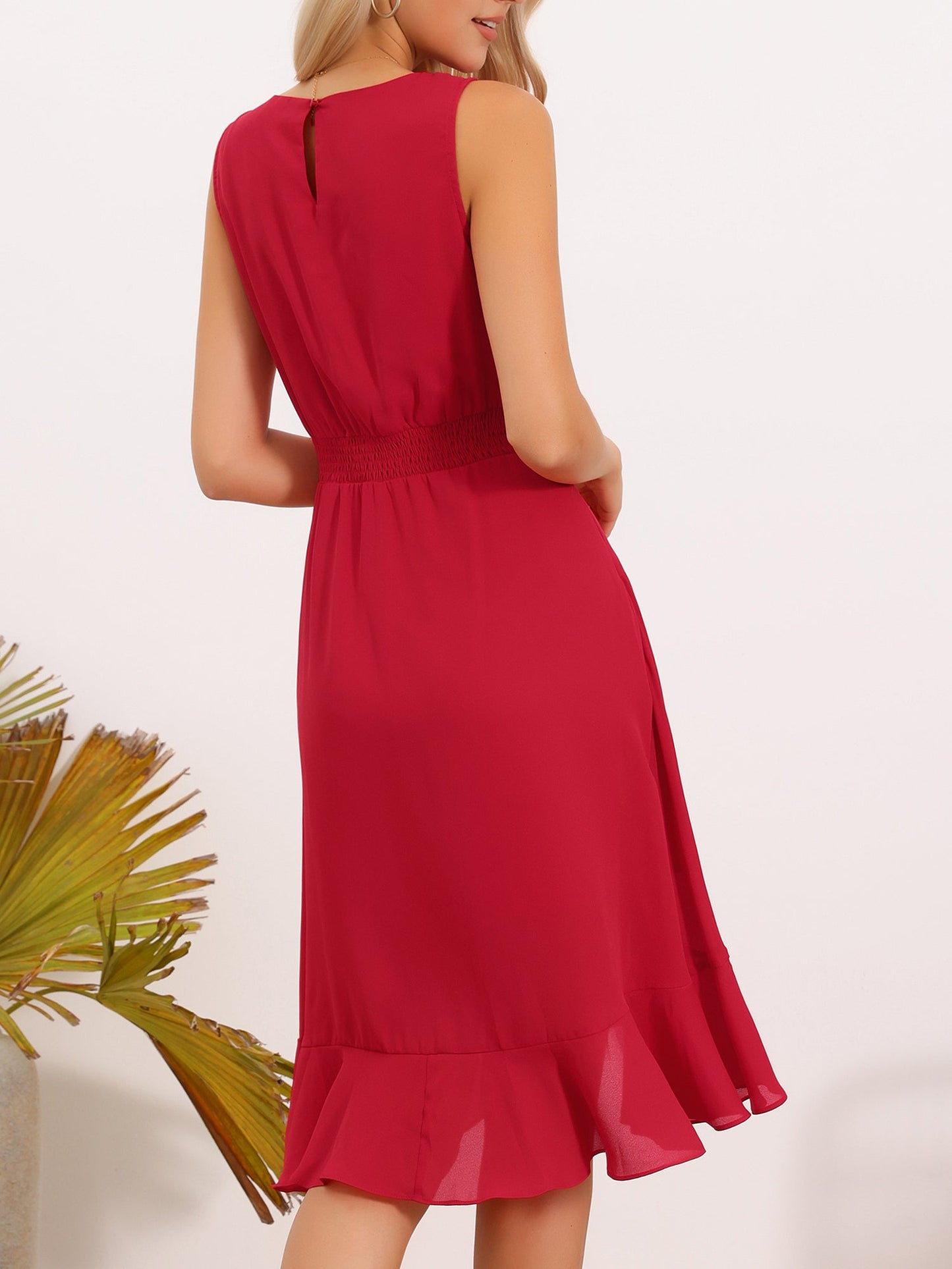 Red - Woman walking outdoors wearing a sleeveless floral chiffon midi sundress with an asymmetrical high-low ruffle hem.