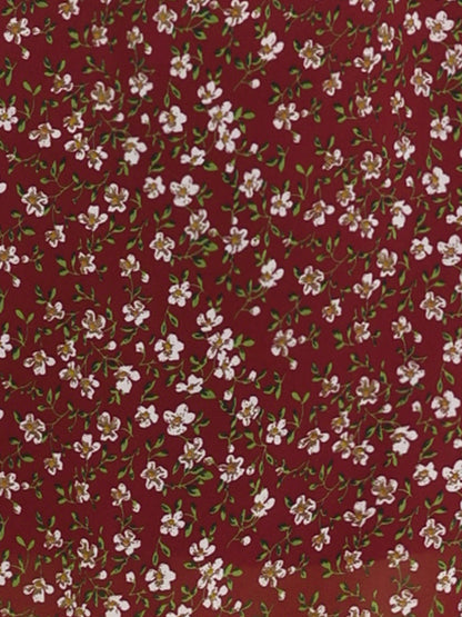 Wine Red - Woman walking outdoors wearing a sleeveless floral chiffon midi sundress with an asymmetrical high-low ruffle hem.