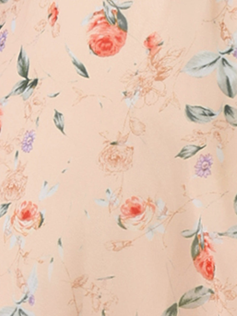 Apricot - Woman walking outdoors wearing a sleeveless floral chiffon midi sundress with an asymmetrical high-low ruffle hem.