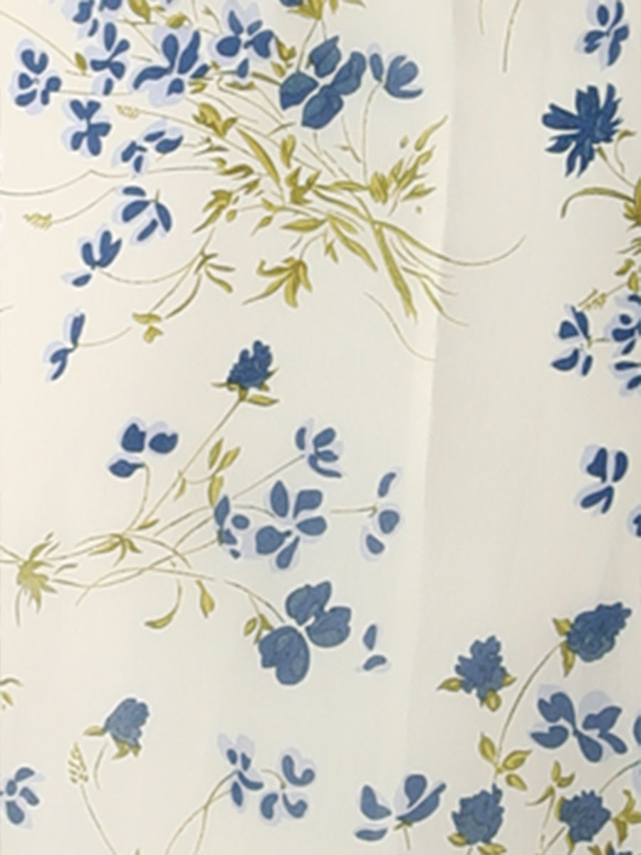 Beige-Blue Floral - Woman walking outdoors wearing a sleeveless floral chiffon midi sundress with an asymmetrical high-low ruffle hem.