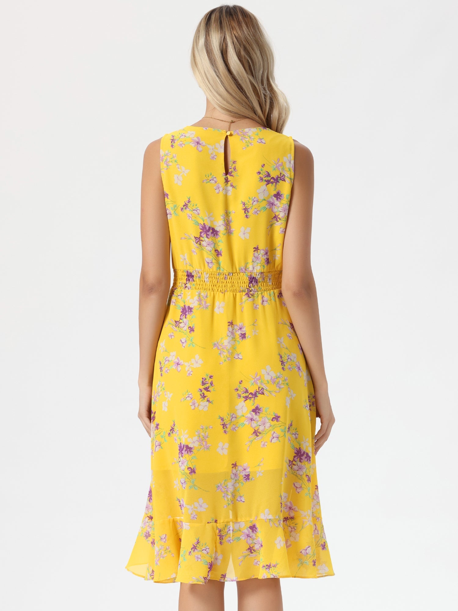 Yellow - Woman walking outdoors wearing a sleeveless floral chiffon midi sundress with an asymmetrical high-low ruffle hem.