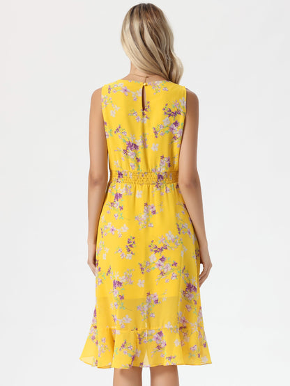 Yellow - Woman walking outdoors wearing a sleeveless floral chiffon midi sundress with an asymmetrical high-low ruffle hem.
