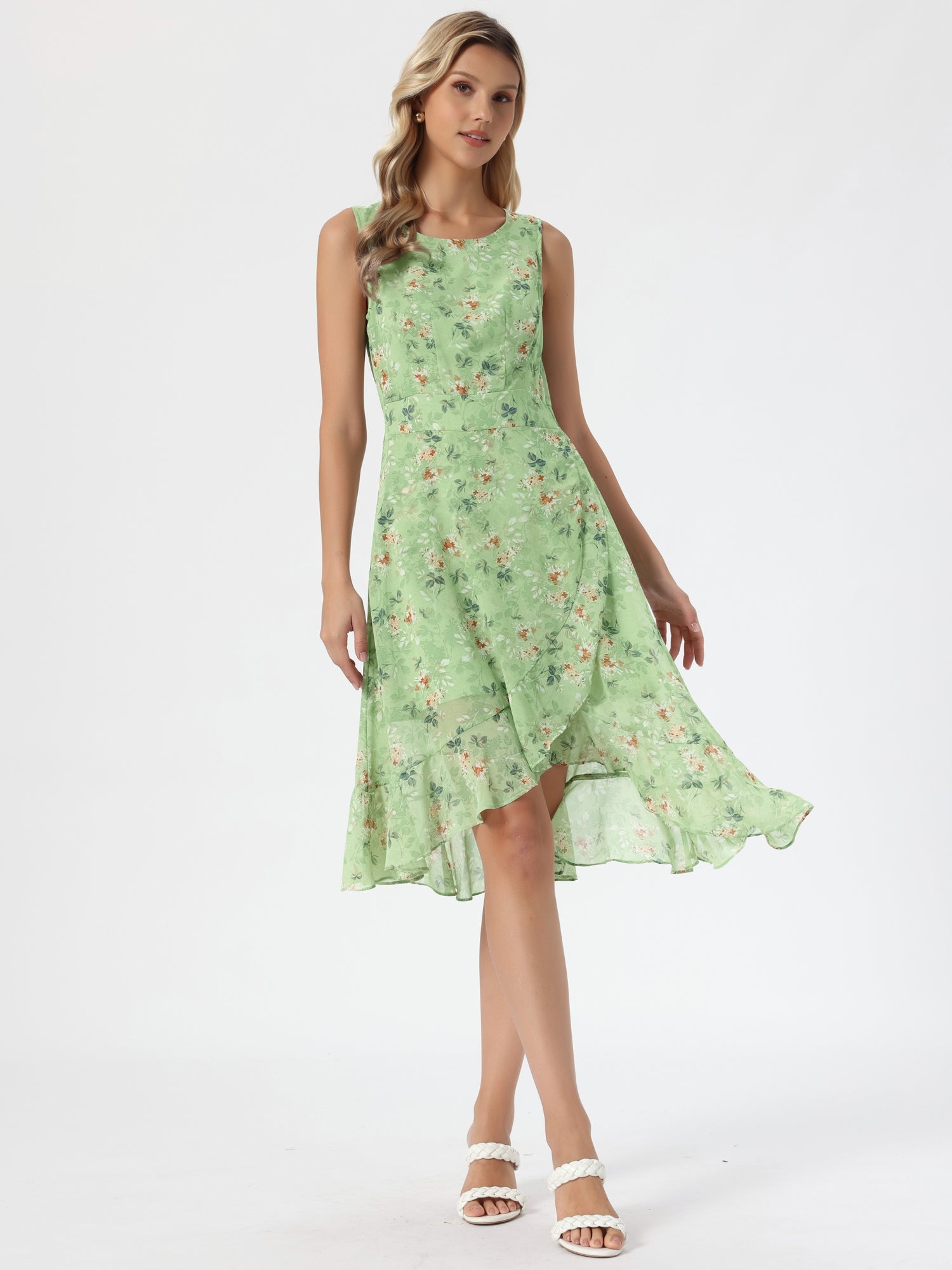 Green - Woman walking outdoors wearing a sleeveless floral chiffon midi sundress with an asymmetrical high-low ruffle hem.