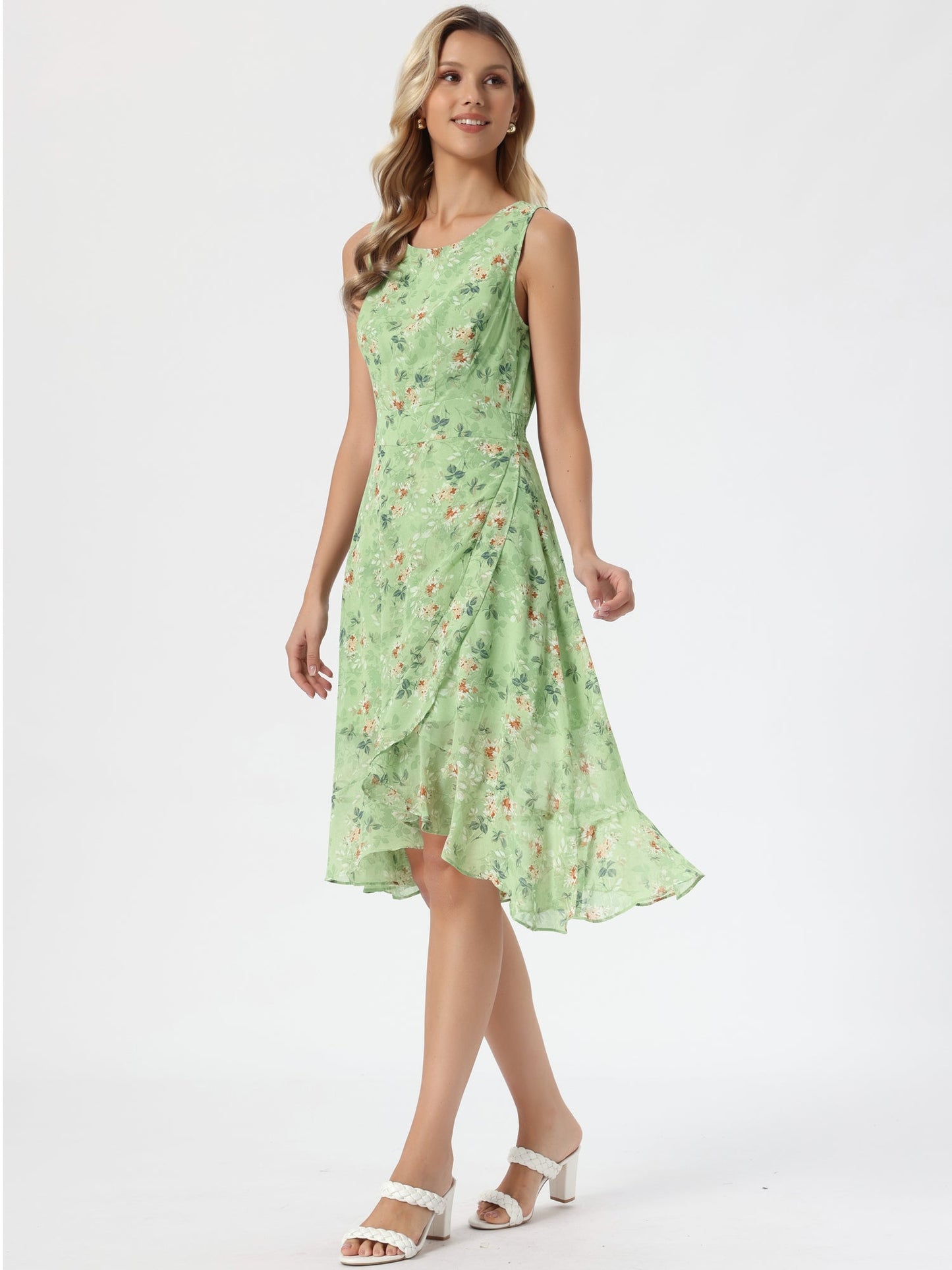 Green - Woman walking outdoors wearing a sleeveless floral chiffon midi sundress with an asymmetrical high-low ruffle hem.